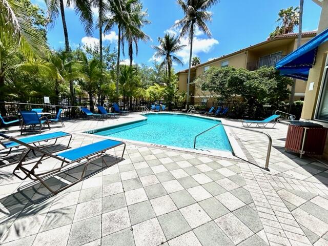 741 North Pine Island Road, Unit 303 Plantation, FL 33324 - Photo 28 of 32 a lawn chairs sitting in a backyard