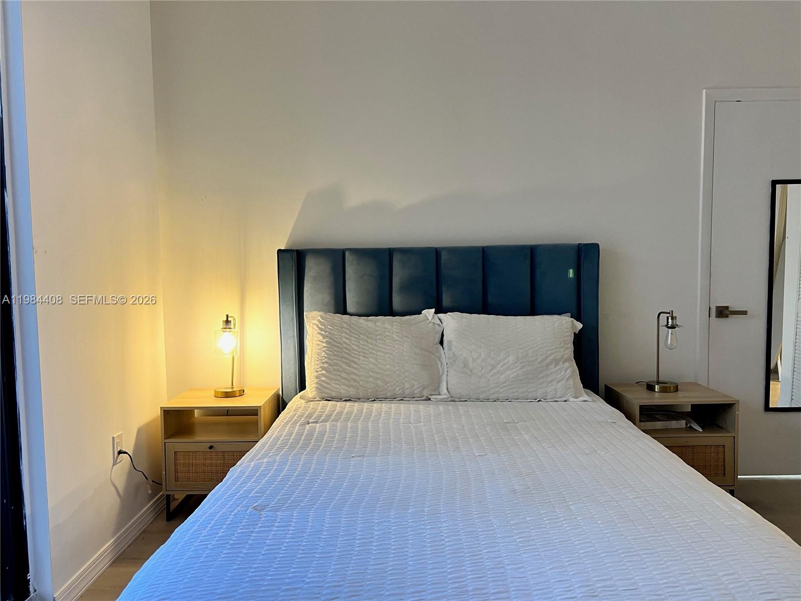 540 Brickell Key Drive, Unit 202 Miami, FL 33131 - Photo 20 of 31 a bed room with a bed and a night stand