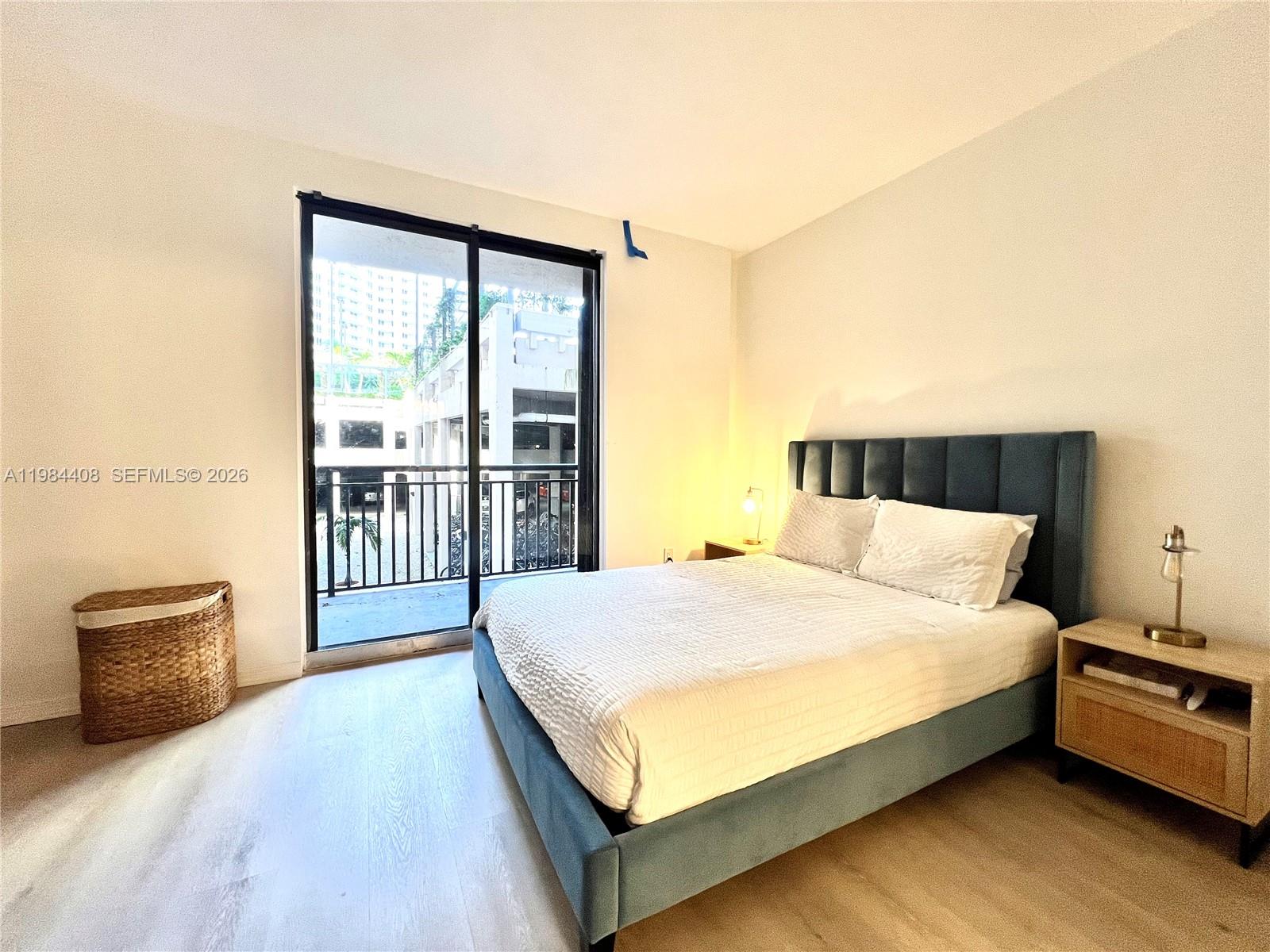 540 Brickell Key Drive, Unit 202 Miami, FL 33131 - Photo 21 of 31 a large bed sitting in a bedroom next to a window