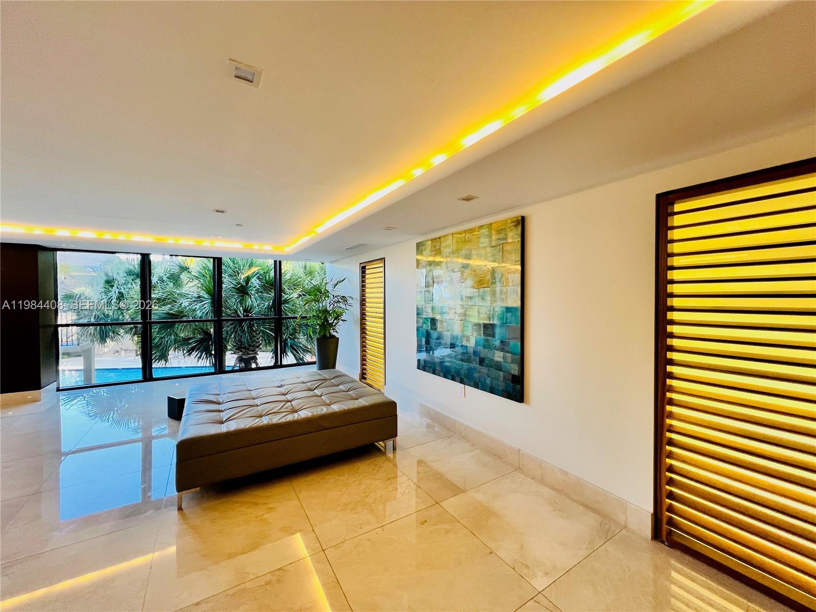 540 Brickell Key Drive, Unit 202 Miami, FL 33131 - Photo 27 of 31 a room with a bed and a large window
