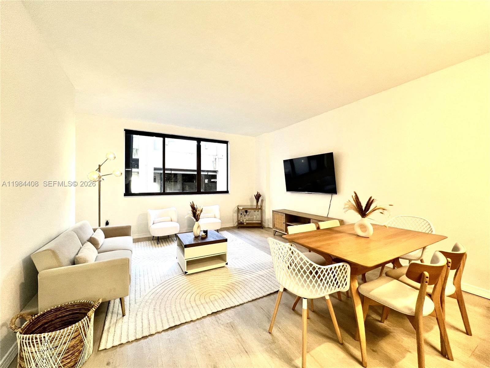 540 Brickell Key Drive, Unit 202 Miami, FL 33131 - Photo 3 of 31 a balcony with furniture and a flat screen tv