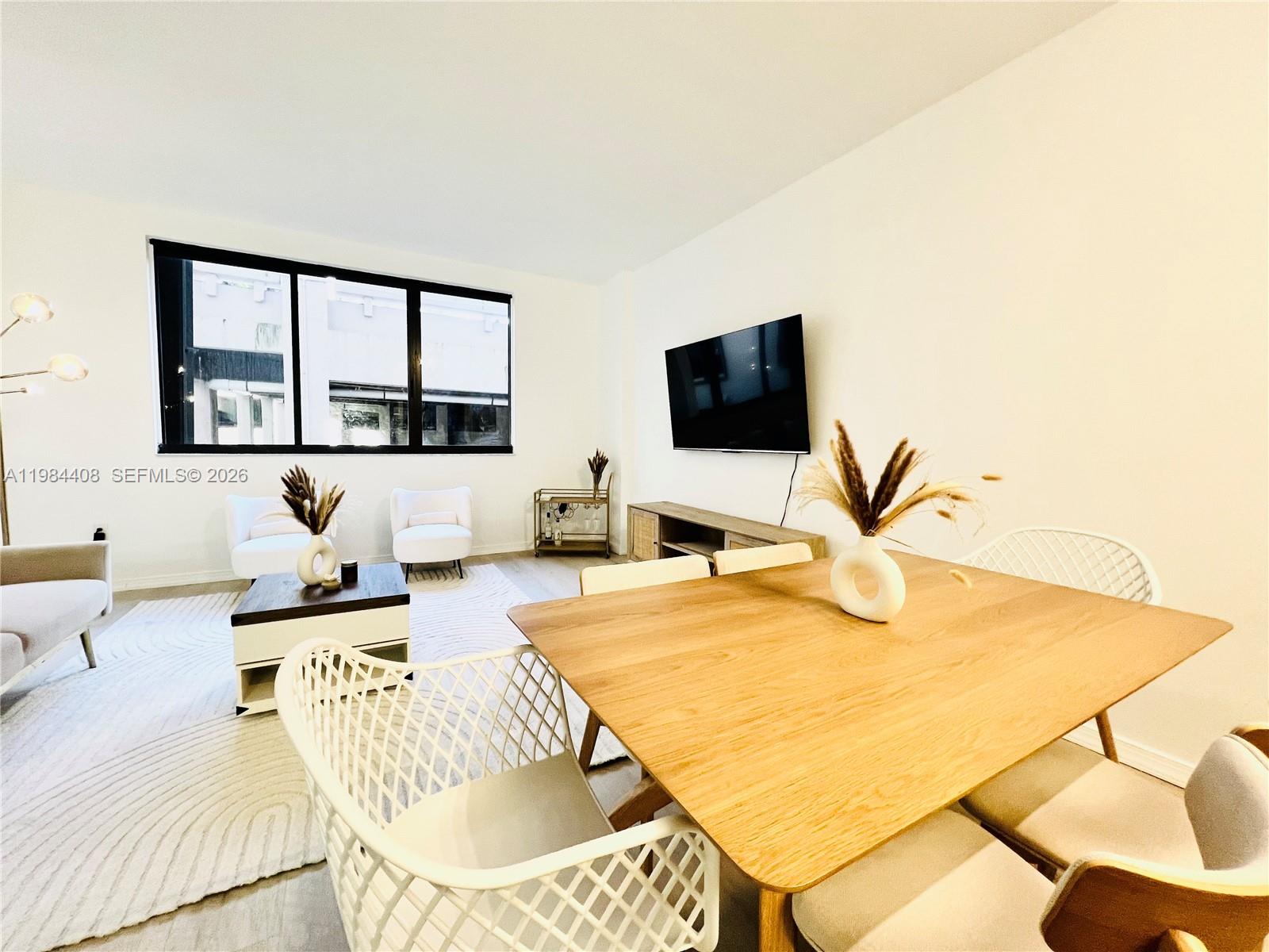 540 Brickell Key Drive, Unit 202 Miami, FL 33131 - Photo 4 of 31 a living room with furniture and a flat screen tv