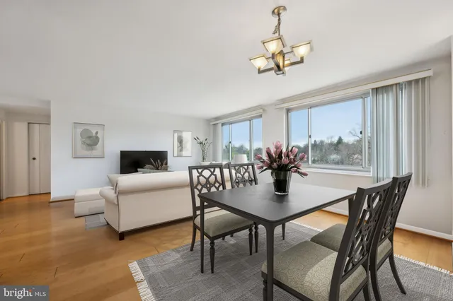 a dining room with furniture a window and a chandelier