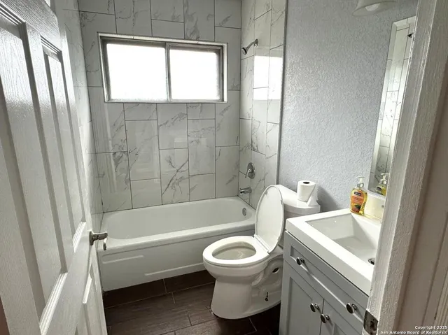 a bathroom with a sink a toilet and a bathtub