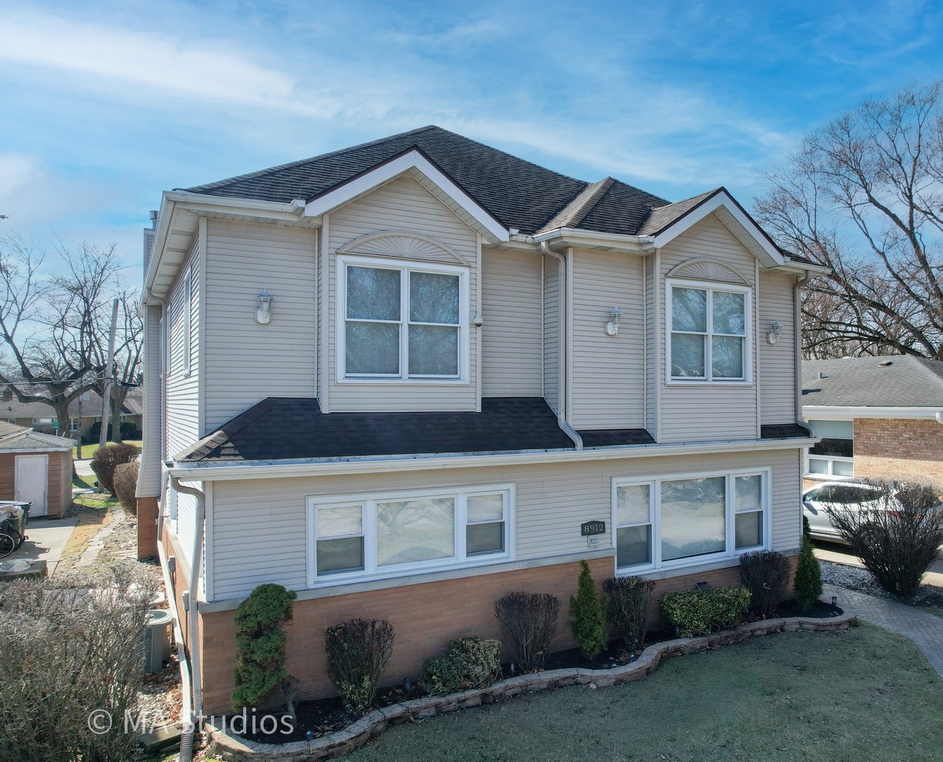 8912 Harms Road Morton Grove, IL 60053 - Photo 1 of 85 a front view of a house with a yard and garage