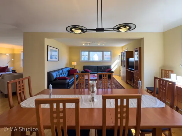 a living room with lots of furniture and a chandelier