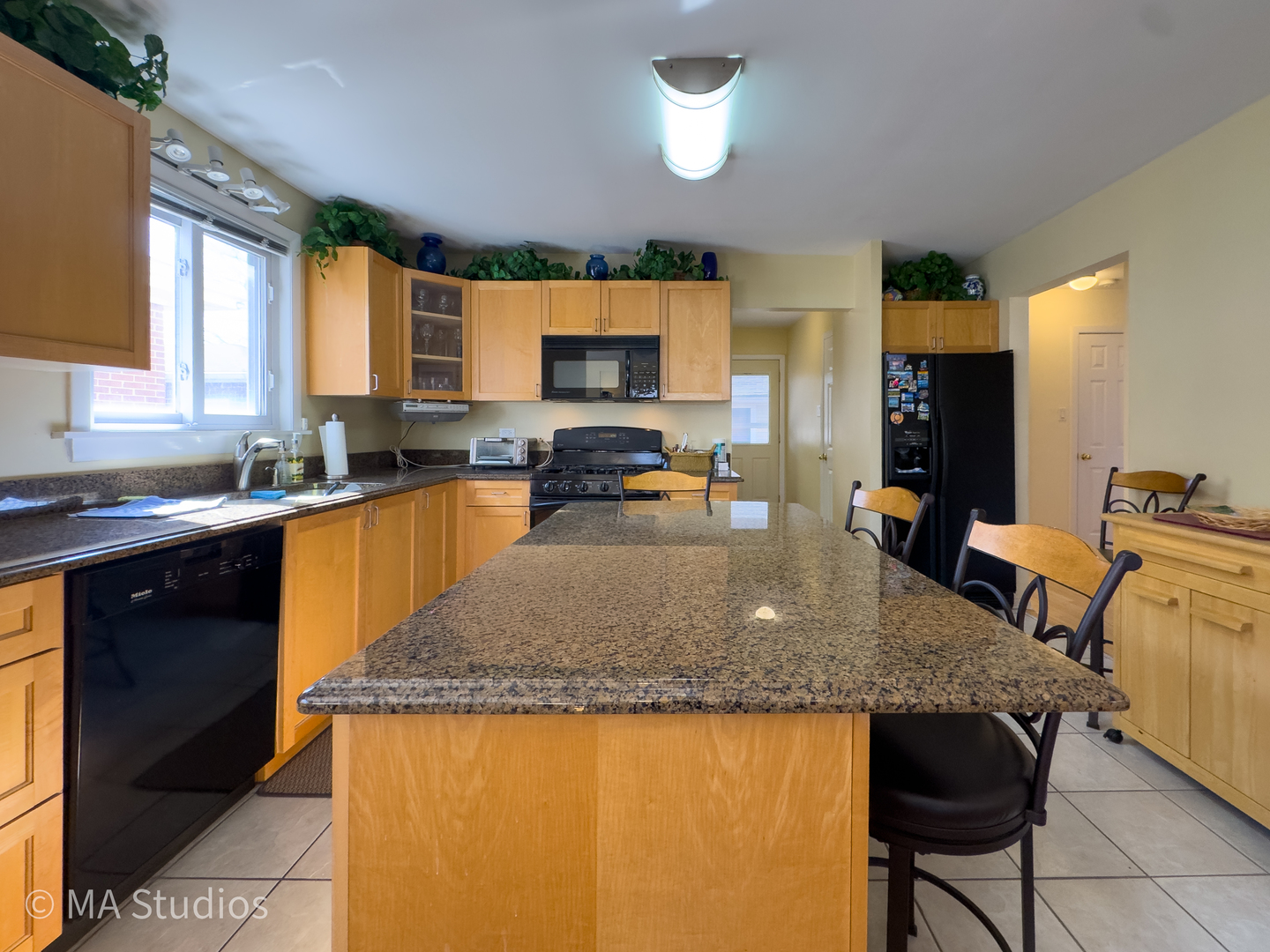 8912 Harms Road Morton Grove, IL 60053 - Photo 18 of 85 a kitchen with granite countertop a sink and a stove