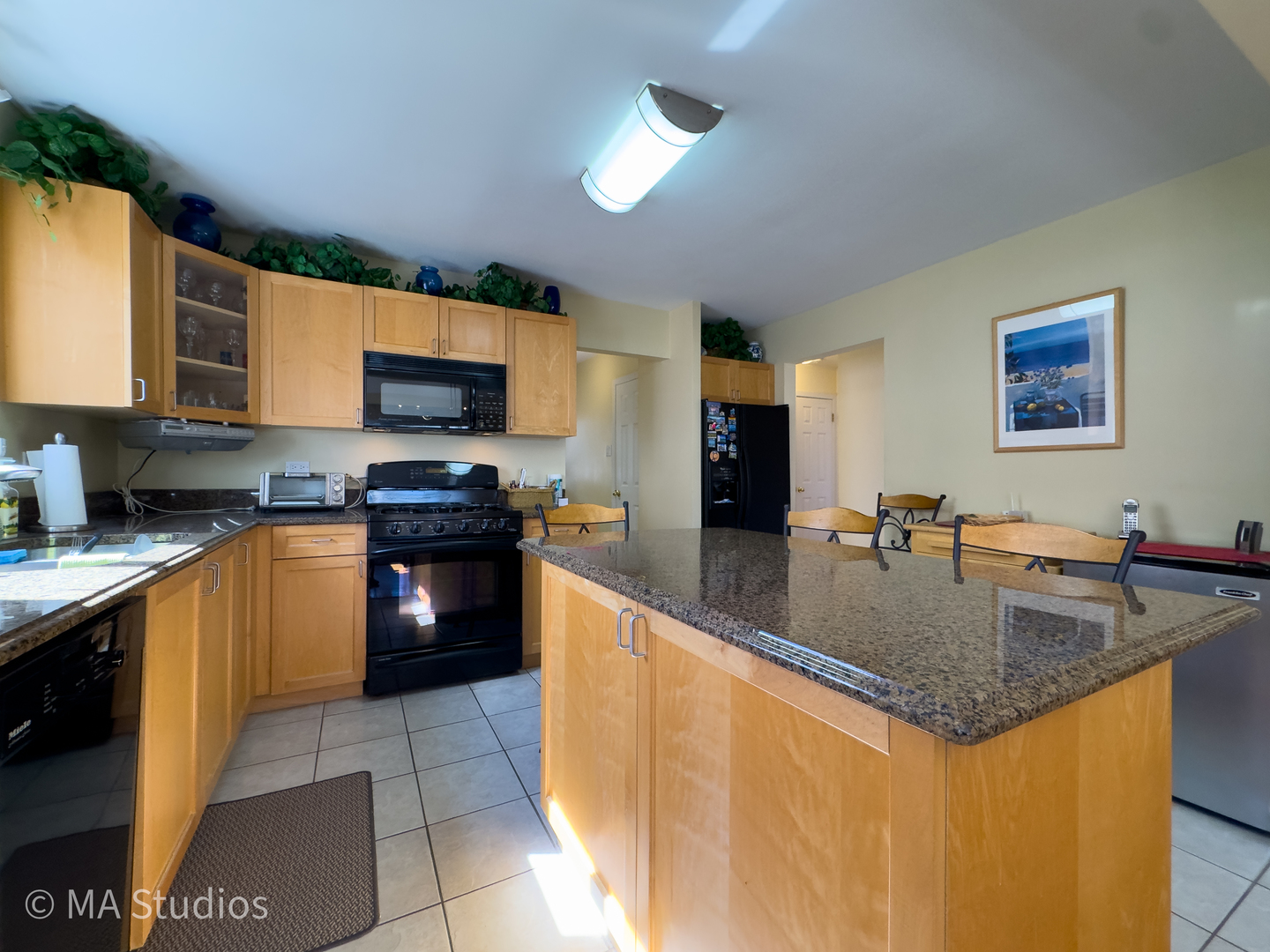 8912 Harms Road Morton Grove, IL 60053 - Photo 19 of 85 a kitchen with stainless steel appliances granite countertop a sink a stove and a refrigerator