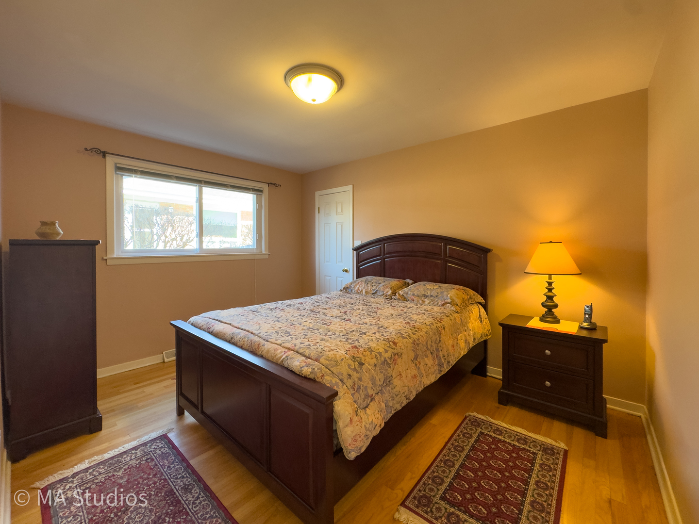 8912 Harms Road Morton Grove, IL 60053 - Photo 24 of 85 a bedroom with a bed and wooden floor