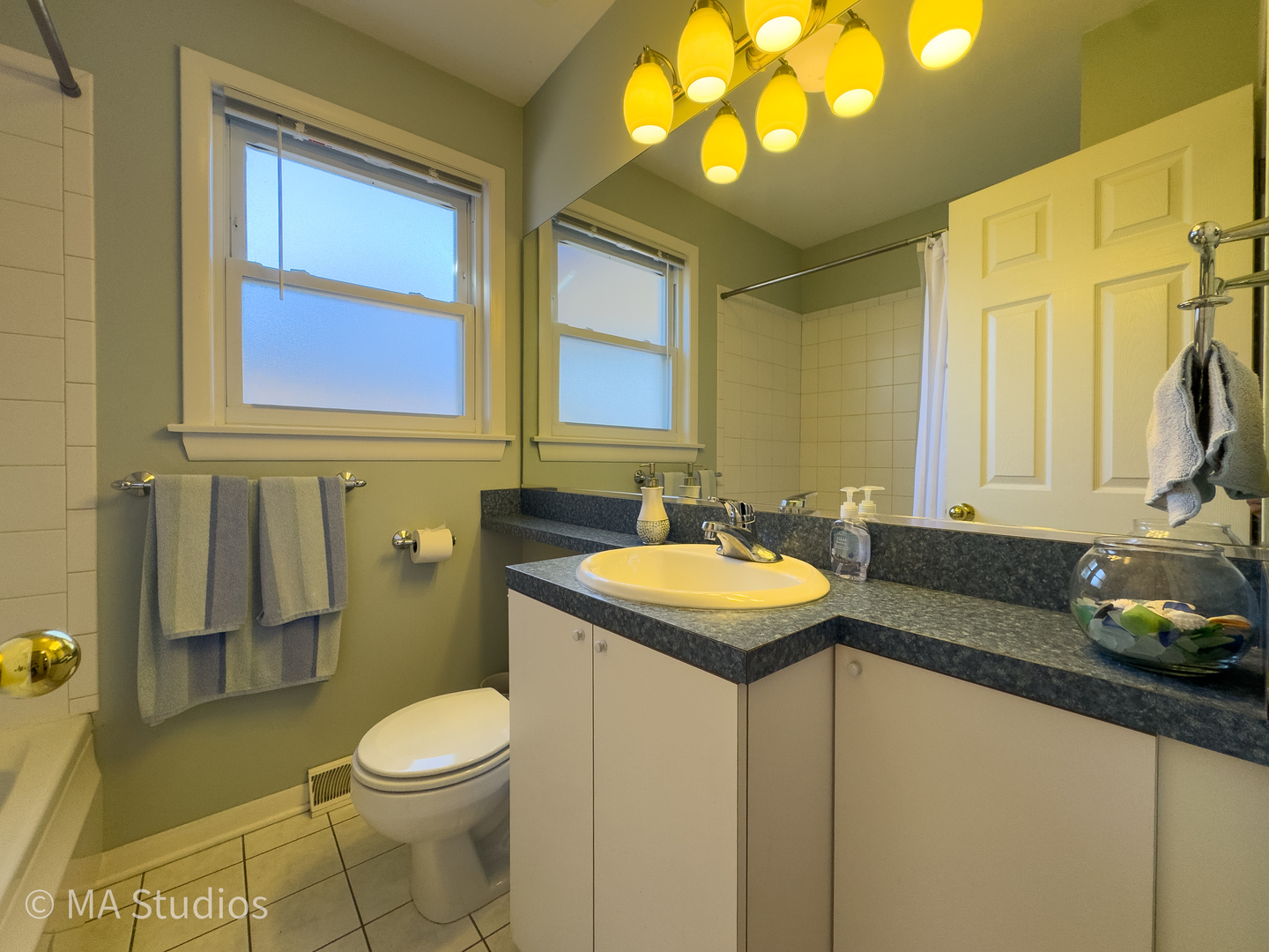 8912 Harms Road Morton Grove, IL 60053 - Photo 29 of 85 a bathroom with a granite countertop sink and a mirror