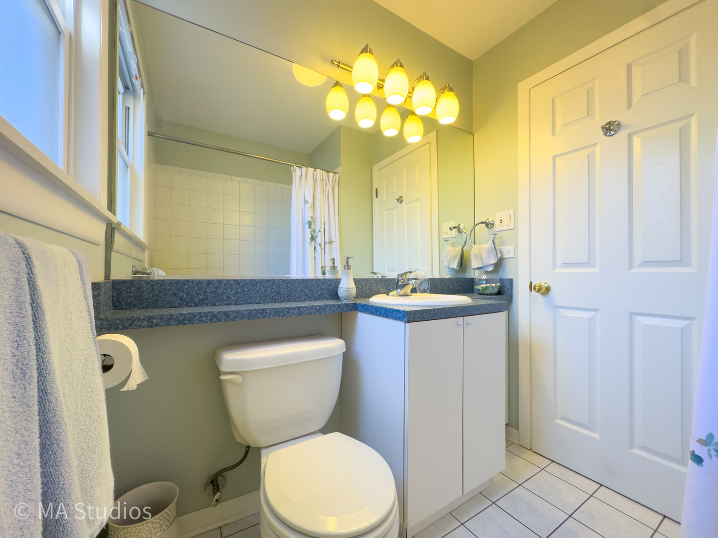 8912 Harms Road Morton Grove, IL 60053 - Photo 30 of 85 a bathroom with a toilet sink and mirror