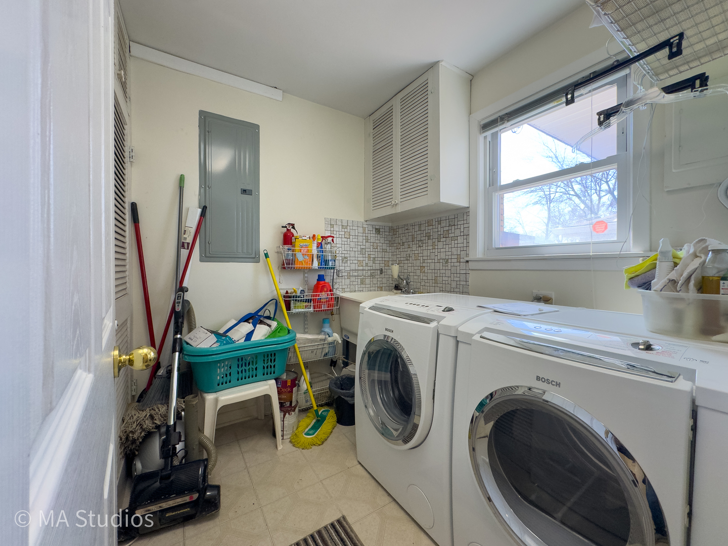 8912 Harms Road Morton Grove, IL 60053 - Photo 32 of 85 a utility room with dryer washer and a window