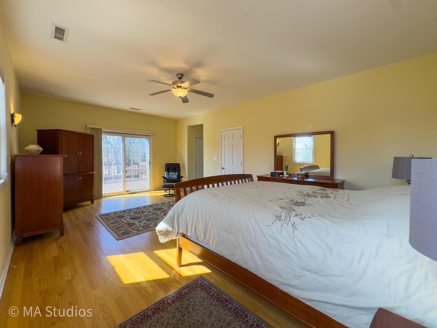 8912 Harms Road Morton Grove, IL 60053 - Photo 39 of 85 a spacious bedroom with a bed a dresser and windows