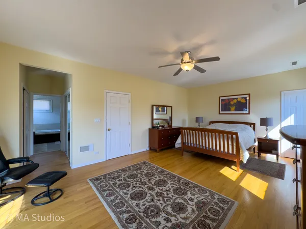 a view of a workspace with furniture and wooden floor