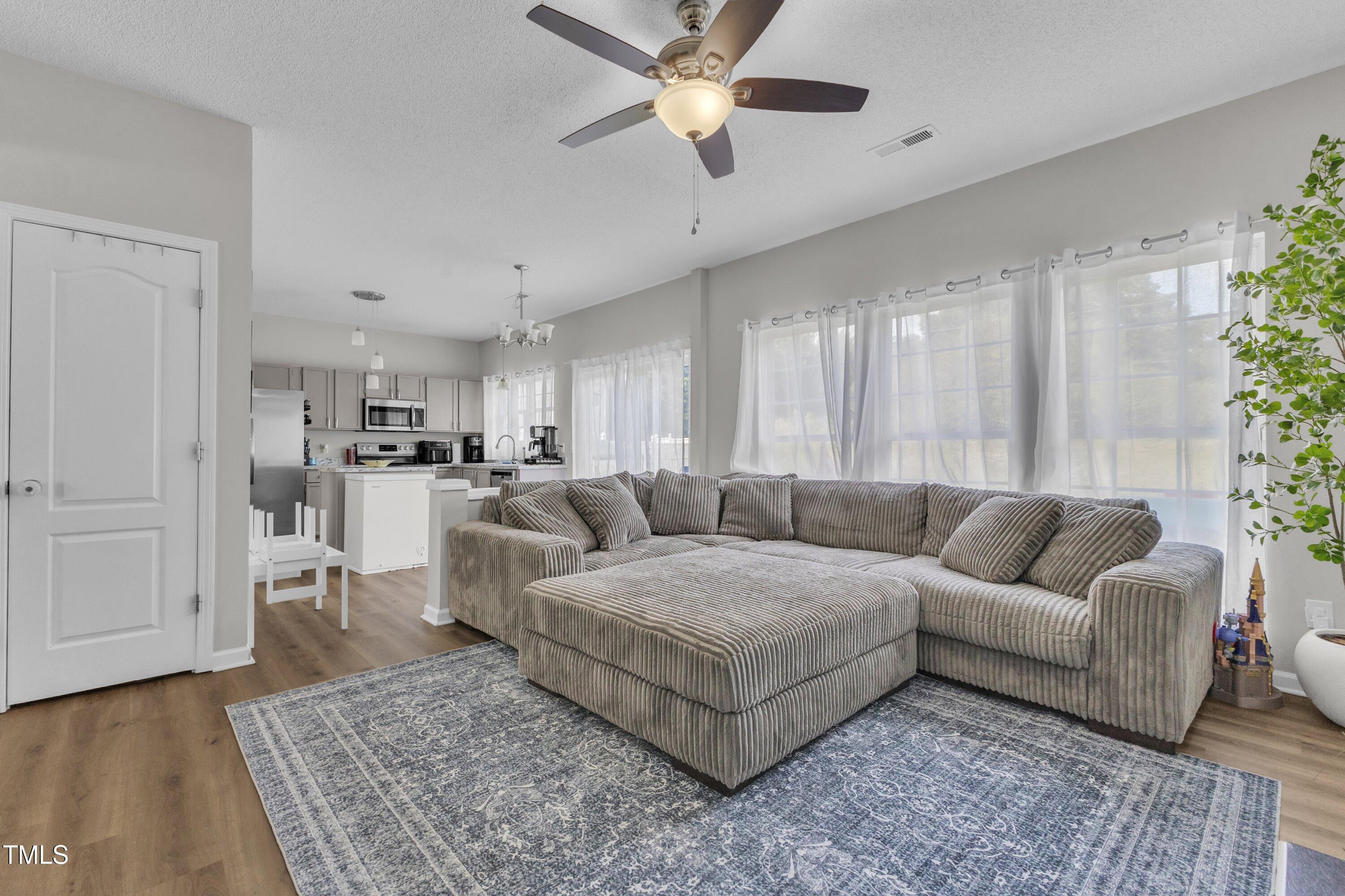 4105 Crowfield Drive Raleigh, NC 27610 - Photo 11 of 38 a living room with furniture and a rug