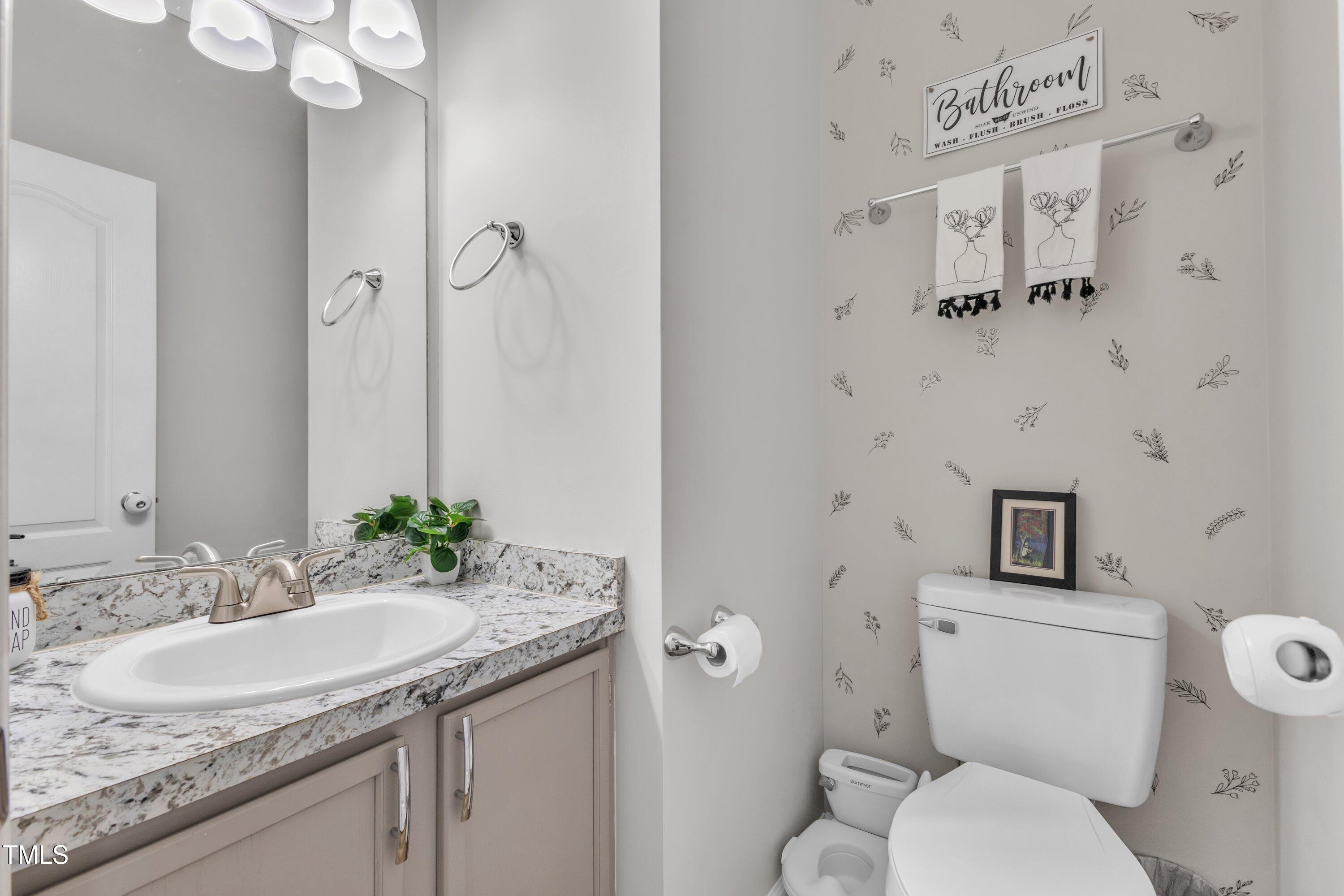 4105 Crowfield Drive Raleigh, NC 27610 - Photo 19 of 38 a bathroom with a granite countertop sink and a toilet