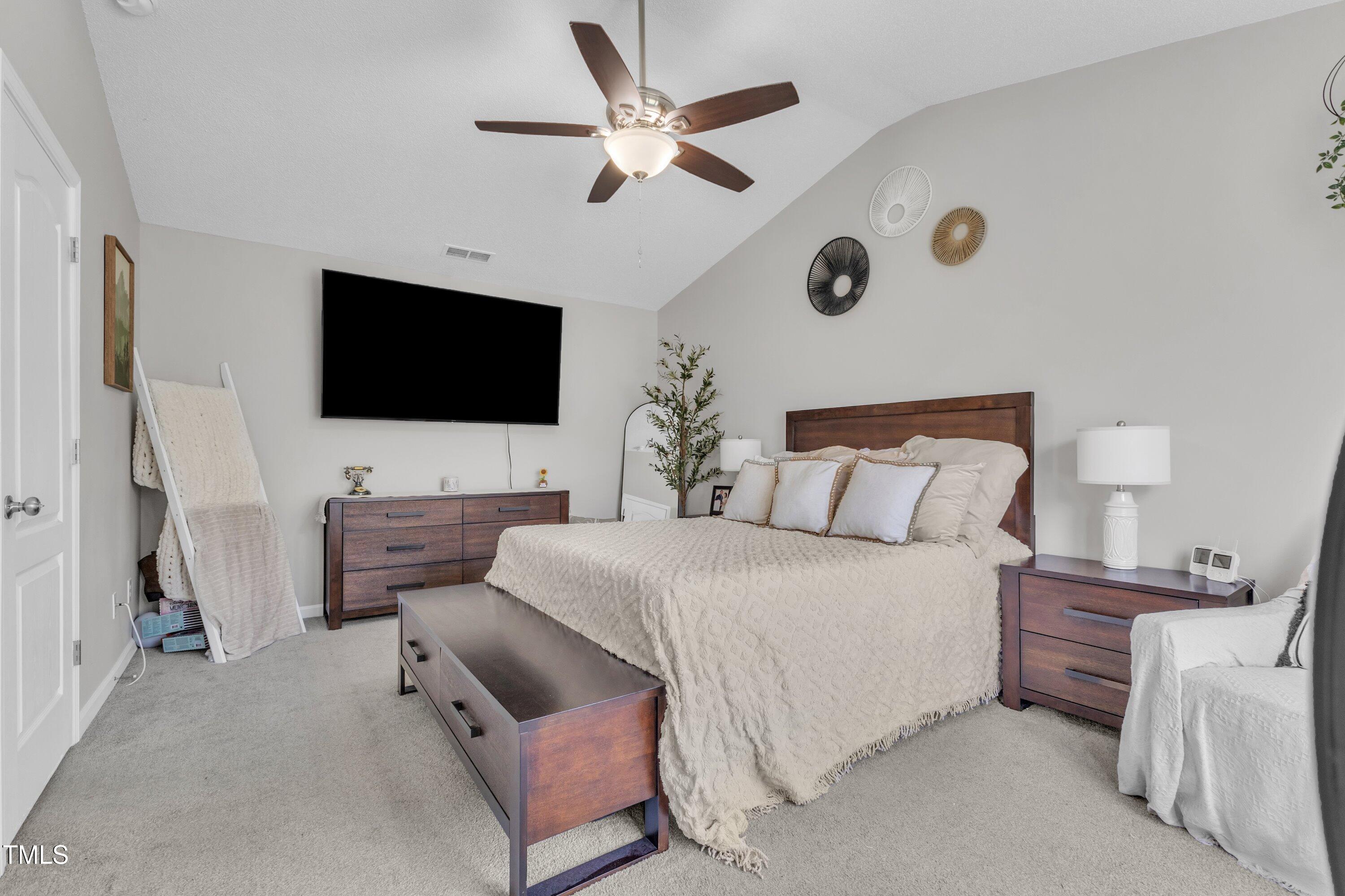 4105 Crowfield Drive Raleigh, NC 27610 - Photo 22 of 38 a bedroom with a bed and a flat screen tv