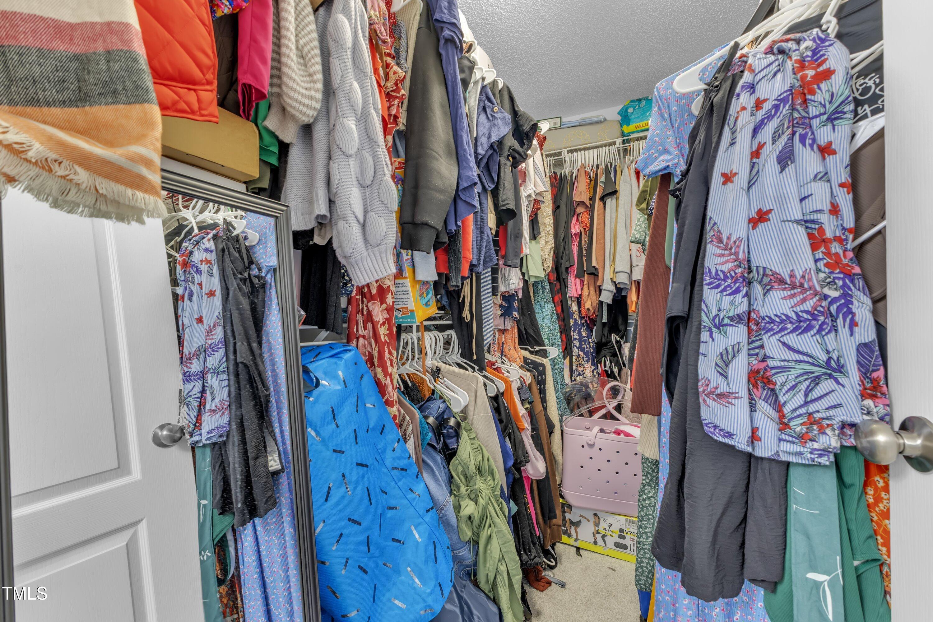 4105 Crowfield Drive Raleigh, NC 27610 - Photo 26 of 38 a view of walk in closet with clothes