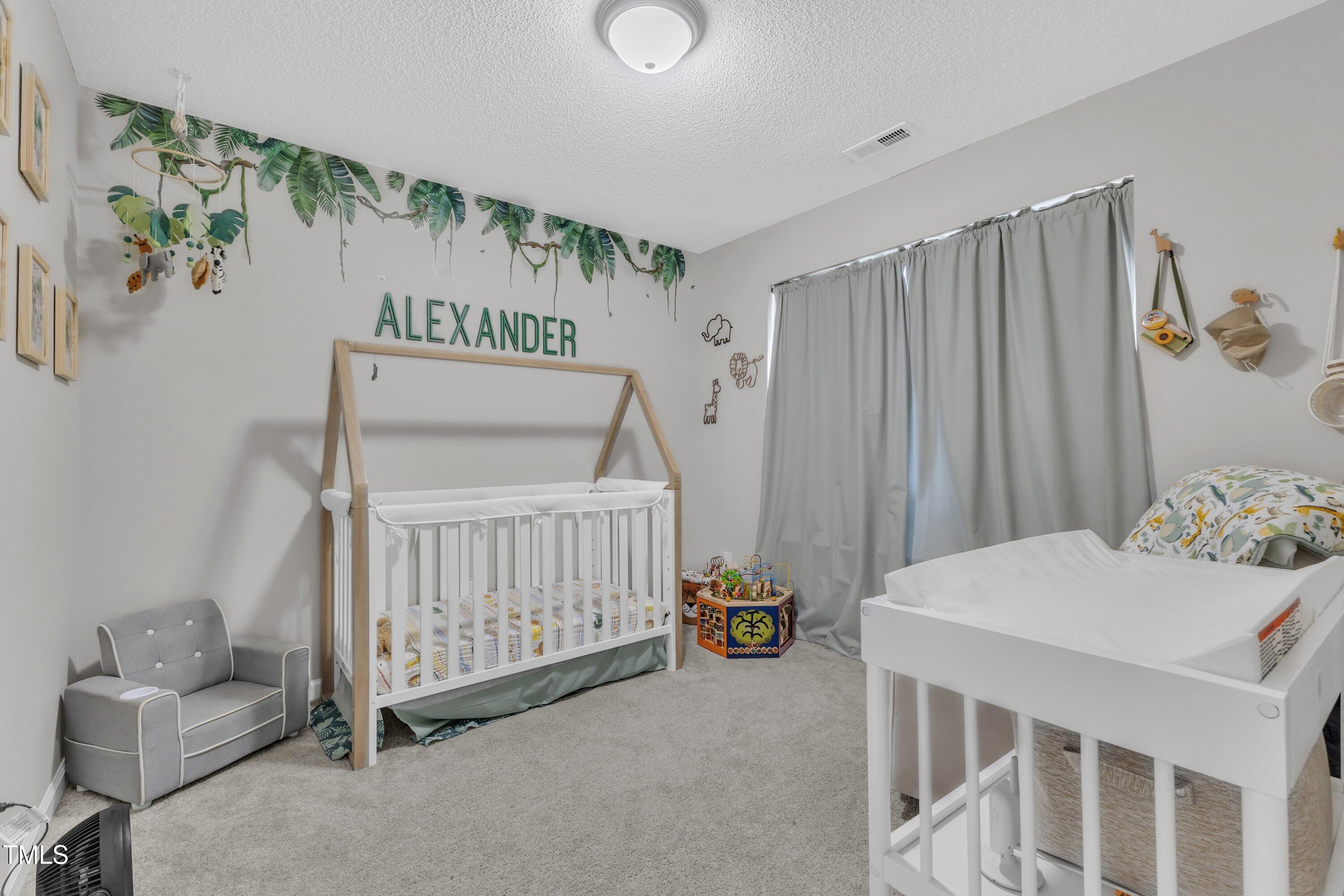4105 Crowfield Drive Raleigh, NC 27610 - Photo 29 of 38 a bedroom with a bed and a table