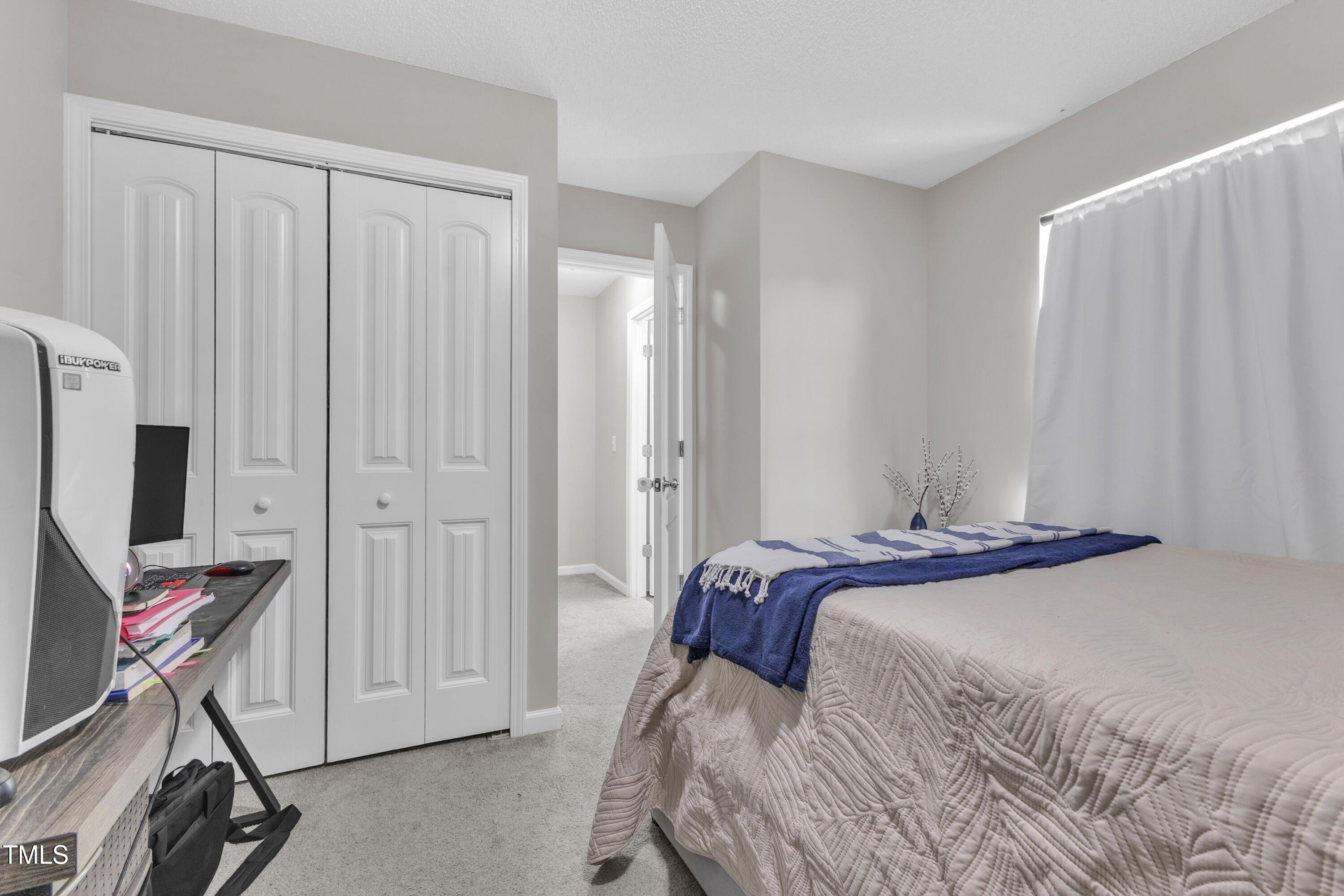 4105 Crowfield Drive Raleigh, NC 27610 - Photo 33 of 38 a bedroom with a bed and a flat screen tv