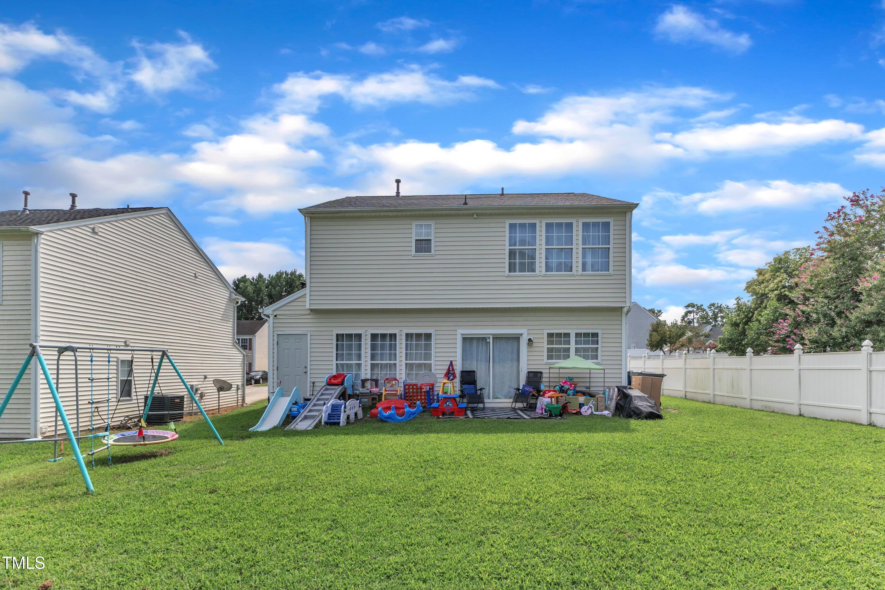 4105 Crowfield Drive Raleigh, NC 27610 - Photo 35 of 38 a group of people sitting in front of a house with a yard