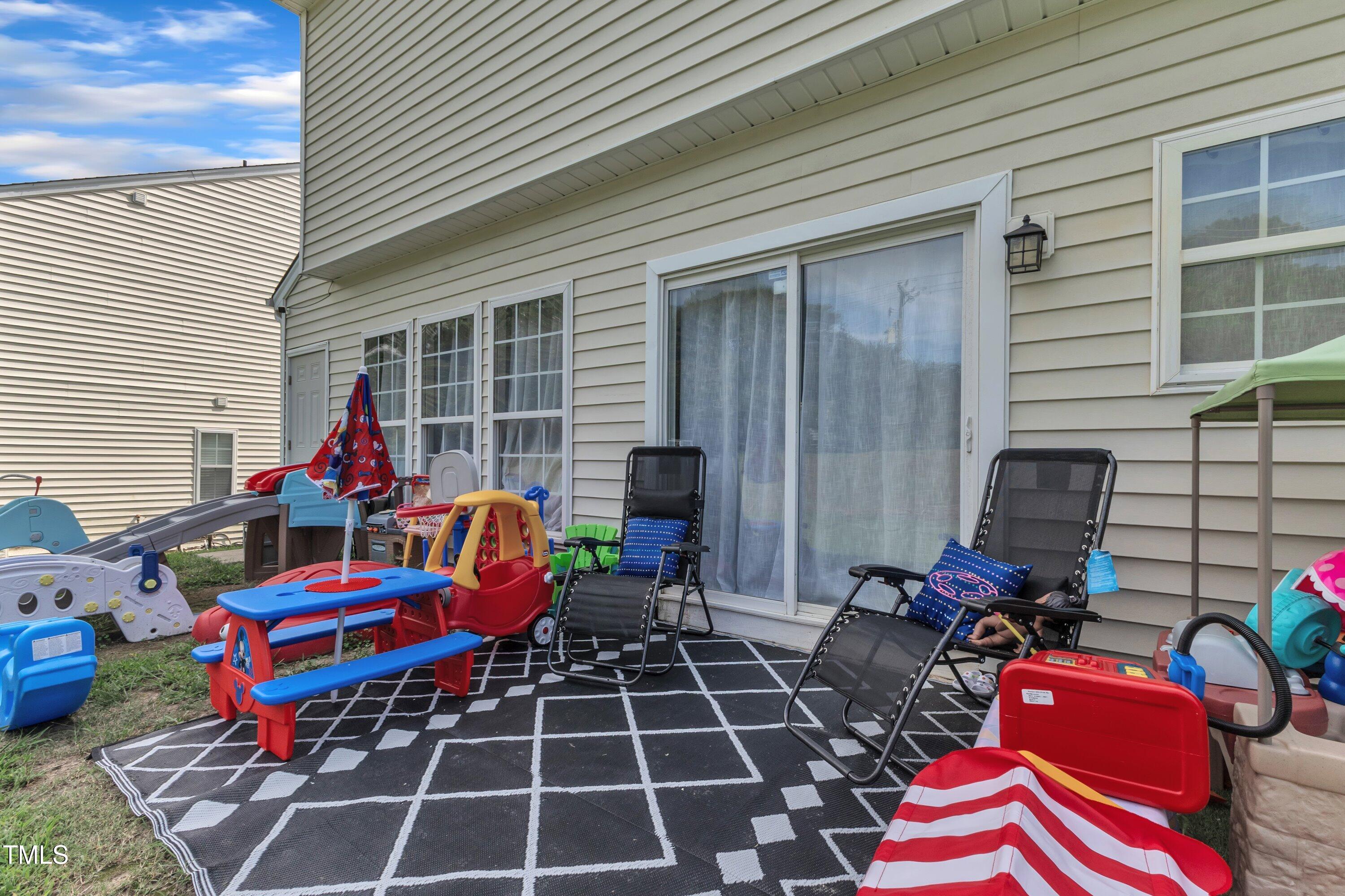 4105 Crowfield Drive Raleigh, NC 27610 - Photo 36 of 38 a building outdoor space with patio furniture and potted plants