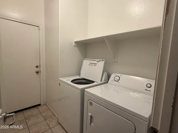 a large kitchen with granite countertop a sink and cabinets