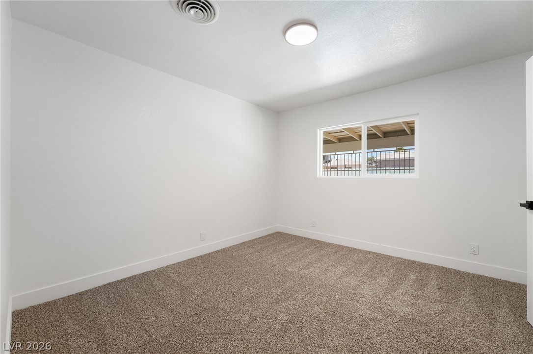 39 Lowery Street Henderson, NV 89015 - Photo 24 of 40 A well-lit bedroom offering a blank canvas for personalization.