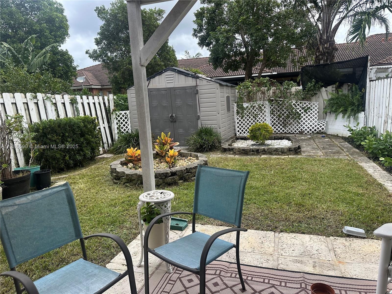 23731 Southwest 110th Avenue Homestead, FL 33032 - Photo 11 of 12 a view of a chairs and table in backyard