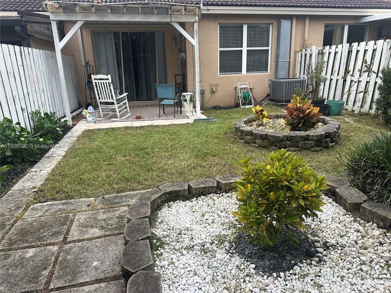 23731 Southwest 110th Avenue Homestead, FL 33032 - Photo 12 of 12 a front view of a house with outdoor seating