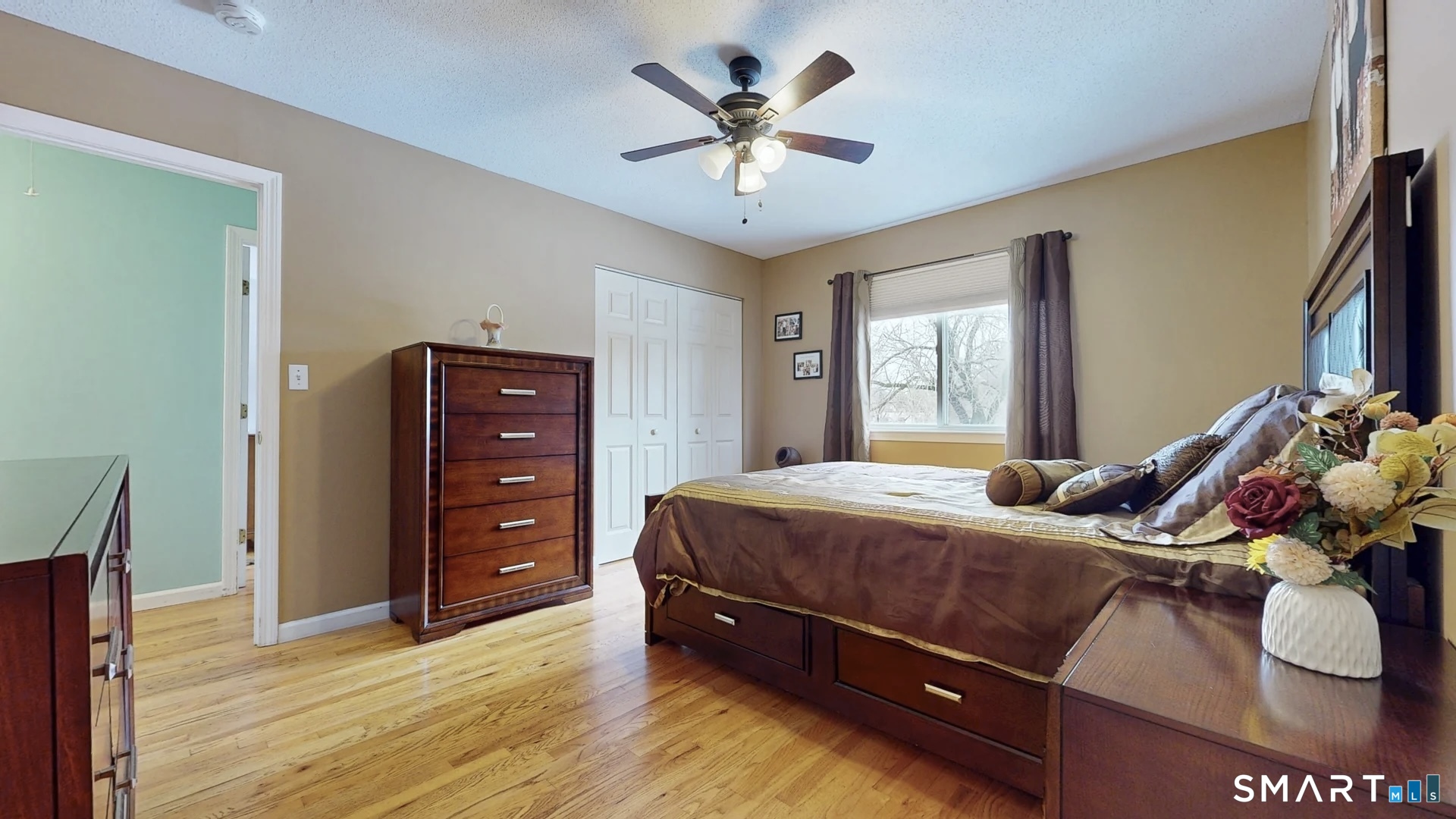 24 Mathew Street Milford, CT 06460 - Photo 9 of 20 a bedroom with a bed and a chandelier