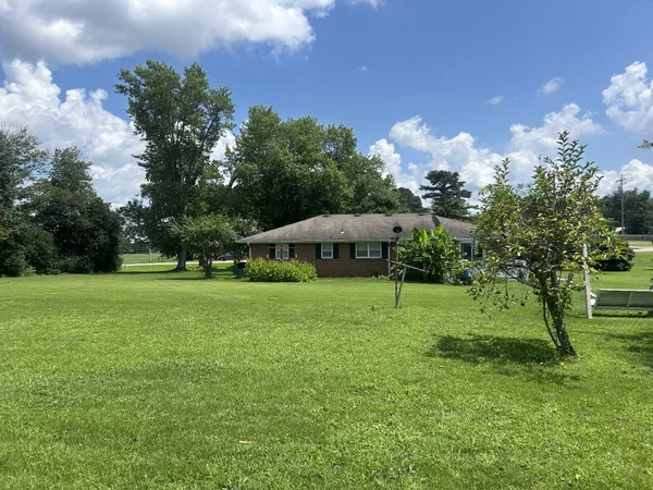 a view of a house with a backyard