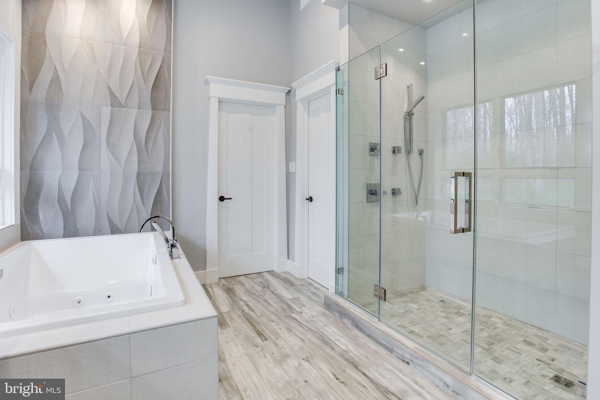 705 Clear Spring Road Great Falls, VA 22066 - Photo 33 of 62 Large jetted tub w/ waterfall tile accent wall