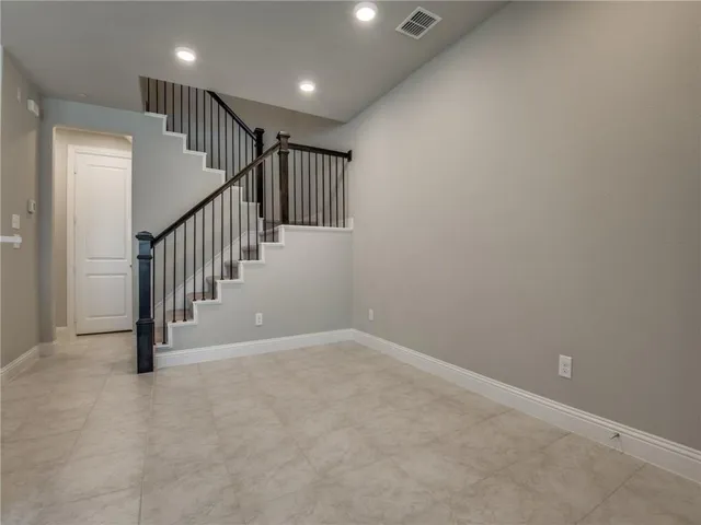 a view of an empty room with stairs