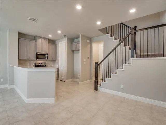 a view of kitchen with microwave and cabinets