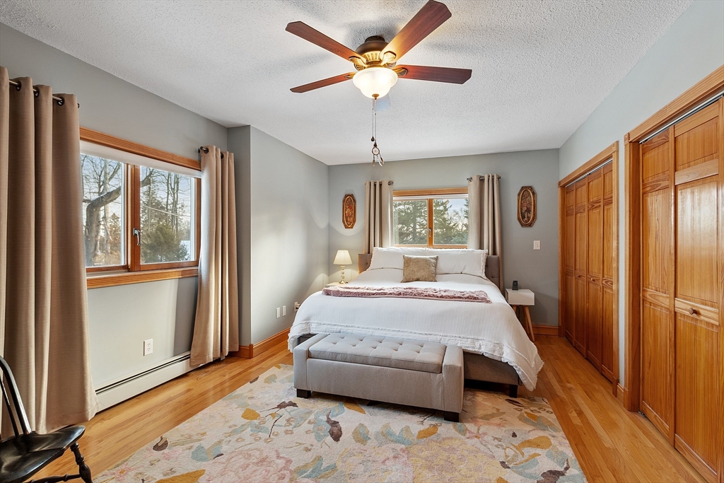 5 Spaulding Hill Road Pelham, NH 03076 - Photo 31 of 40 a bedroom with a bed and a large window with outer view