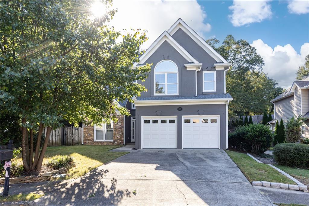 a front view of a house with a yard and garage