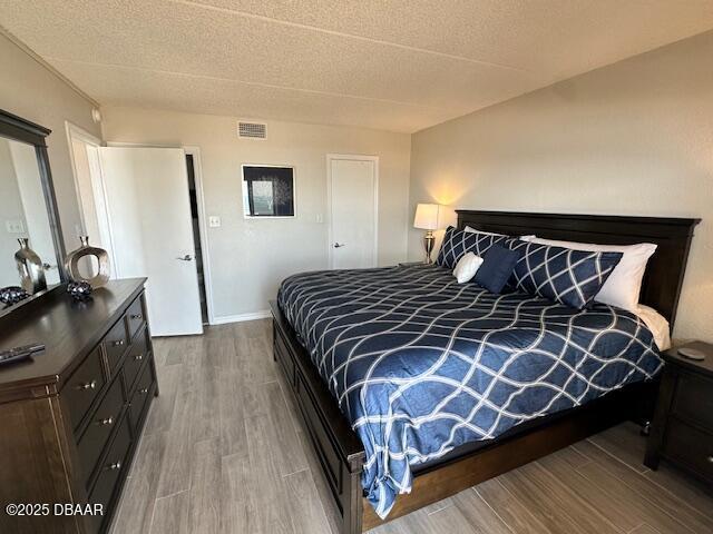 2700 Ocean Shore Boulevard, Unit 301 Ormond Beach, FL 32176 - Photo 26 of 42 a bedroom with a bed and a dresser