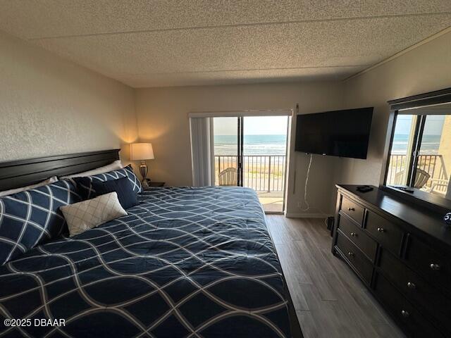 2700 Ocean Shore Boulevard, Unit 301 Ormond Beach, FL 32176 - Photo 27 of 42 a bedroom with a bed and a flat tv screen on the dresser