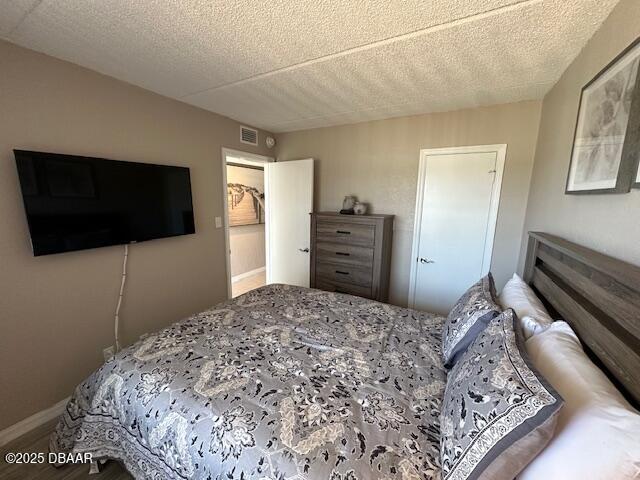 2700 Ocean Shore Boulevard, Unit 301 Ormond Beach, FL 32176 - Photo 31 of 42 a bedroom with a bed and a flat screen tv