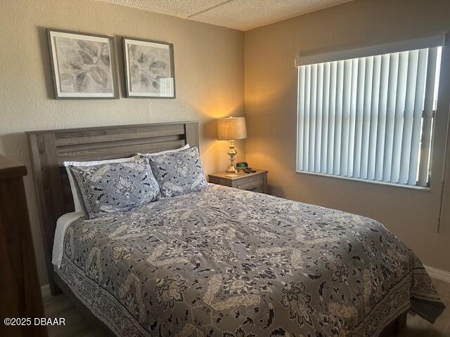2700 Ocean Shore Boulevard, Unit 301 Ormond Beach, FL 32176 - Photo 32 of 42 a large bed sitting in a bedroom next to a lamp