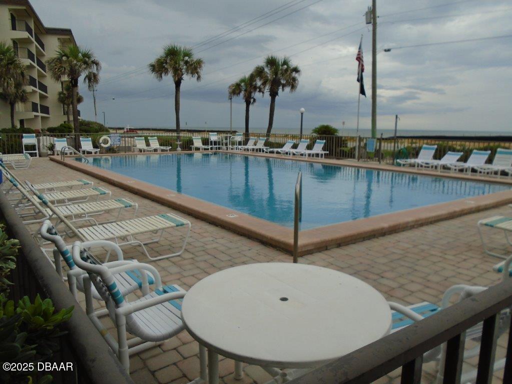 2700 Ocean Shore Boulevard, Unit 301 Ormond Beach, FL 32176 - Photo 34 of 42 a view of a swimming pool with a chair
