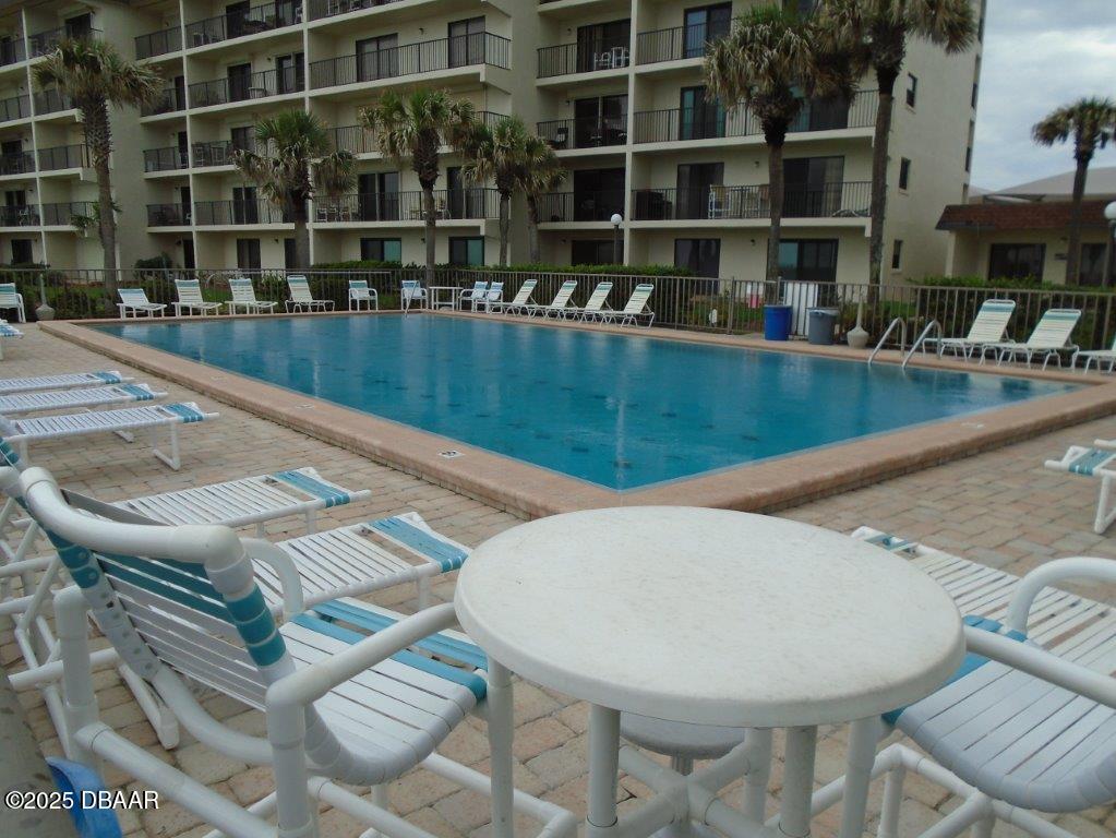 2700 Ocean Shore Boulevard, Unit 301 Ormond Beach, FL 32176 - Photo 38 of 42 a view of a swimming pool with a lounge chairs