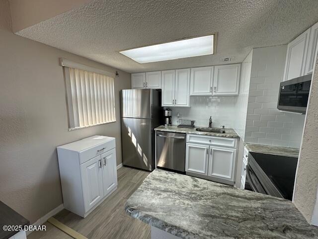 2700 Ocean Shore Boulevard, Unit 301 Ormond Beach, FL 32176 - Photo 5 of 42 a kitchen with a refrigerator sink and stove