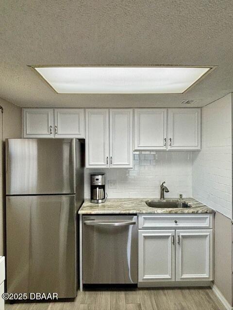 2700 Ocean Shore Boulevard, Unit 301 Ormond Beach, FL 32176 - Photo 6 of 42 a kitchen with a refrigerator and a sink
