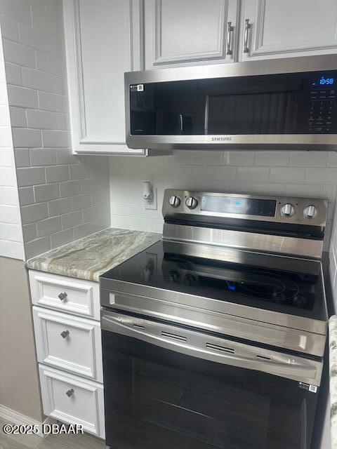 2700 Ocean Shore Boulevard, Unit 301 Ormond Beach, FL 32176 - Photo 7 of 42 a stove top oven sitting inside of a kitchen