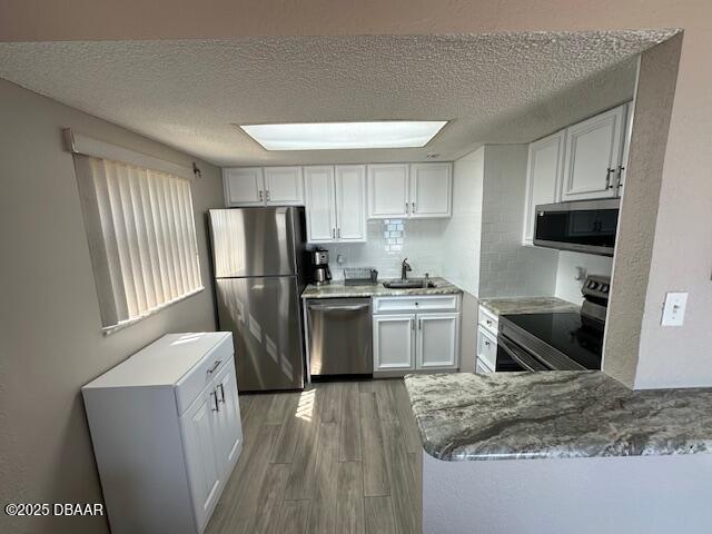 2700 Ocean Shore Boulevard, Unit 301 Ormond Beach, FL 32176 - Photo 8 of 42 a kitchen with a refrigerator a stove top oven a sink dishwasher and wooden cabinets