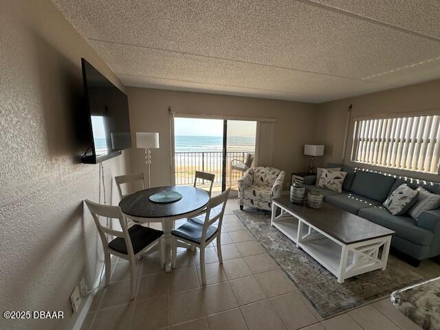 2700 Ocean Shore Boulevard, Unit 301 Ormond Beach, FL 32176 - Photo 9 of 42 a living room with furniture a flat screen tv and a large window