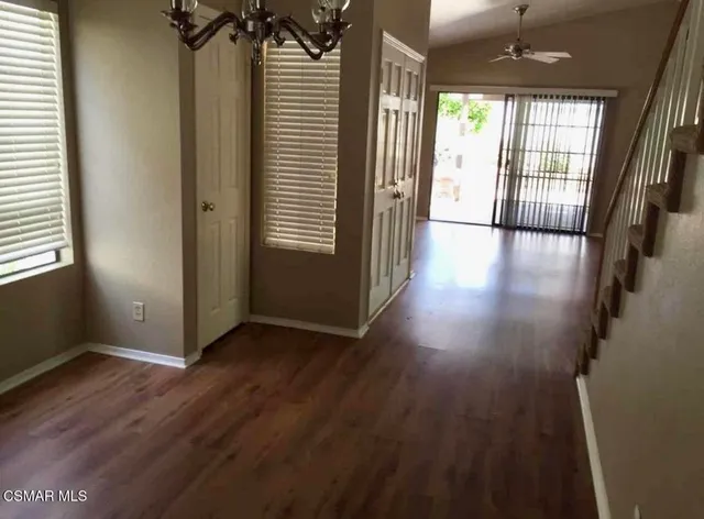 an entryway with a window and wooden floor
