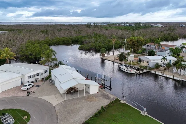 an aerial view of a house with swimming pool and outdoor seating